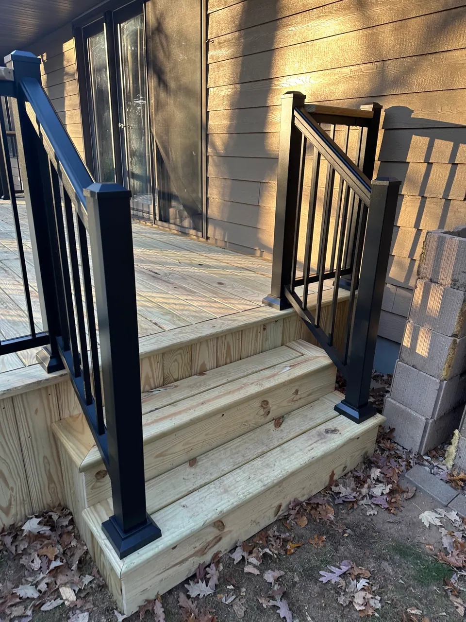 New deck stairs with black aluminum balusters