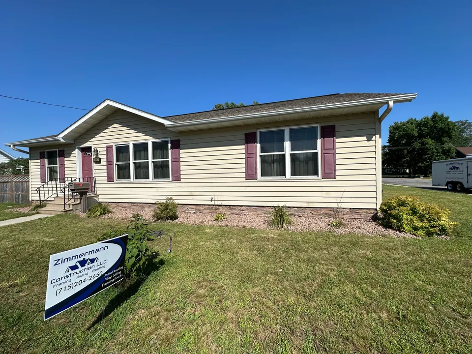 Home with new siding and a Zimmermann Construction yard sign