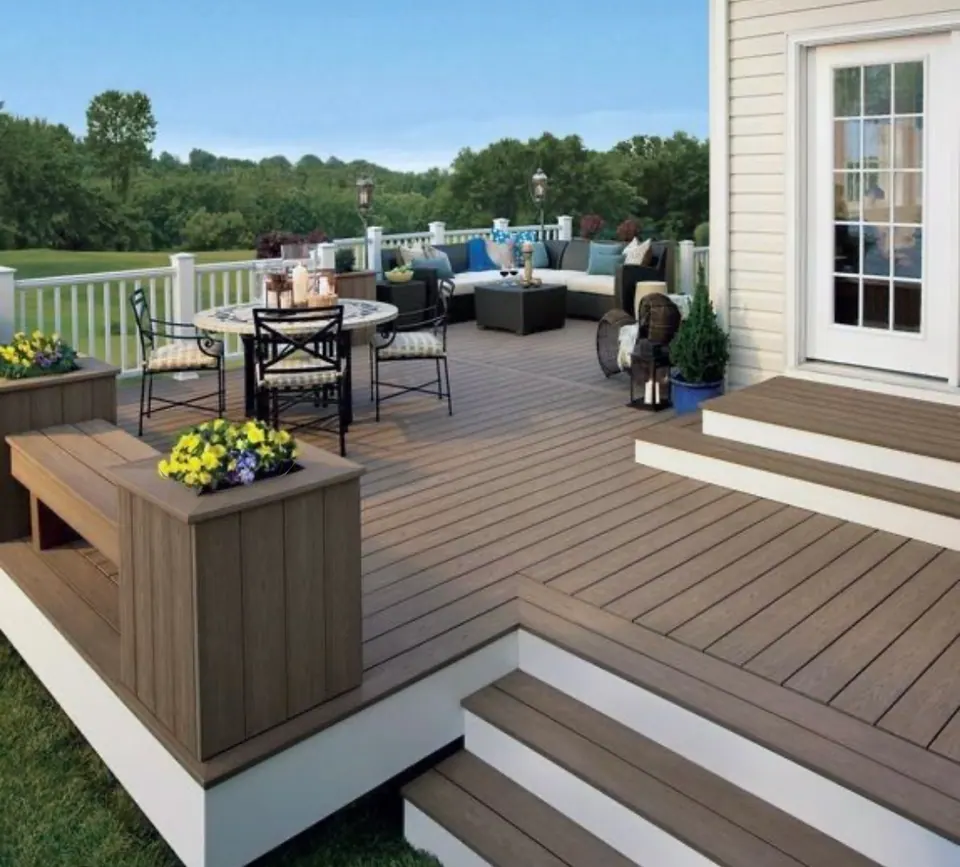 Multi-level composite deck with built-in planter and patio furniture
